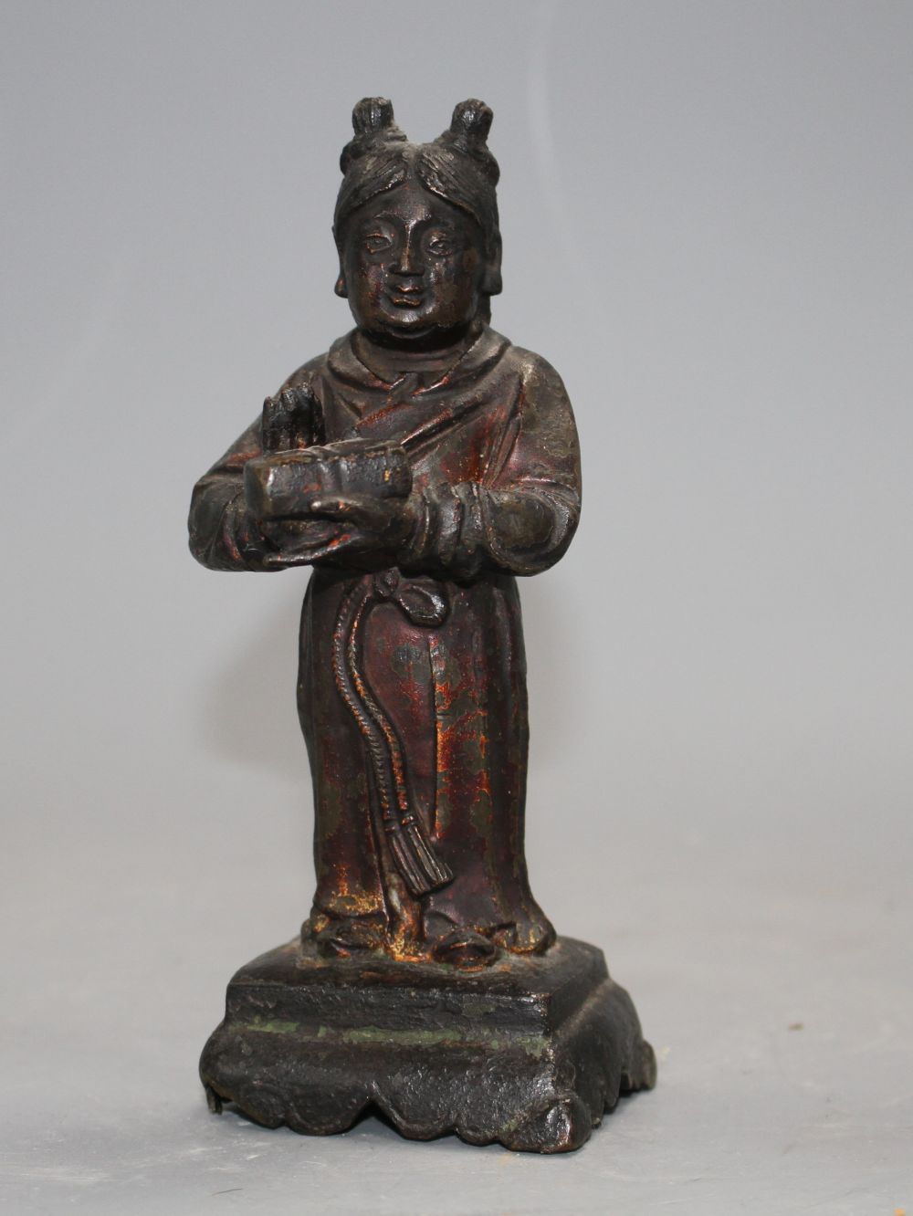 A 17th century Chinese bronze figure, with remnants of polychrome lacquer, h.16cm